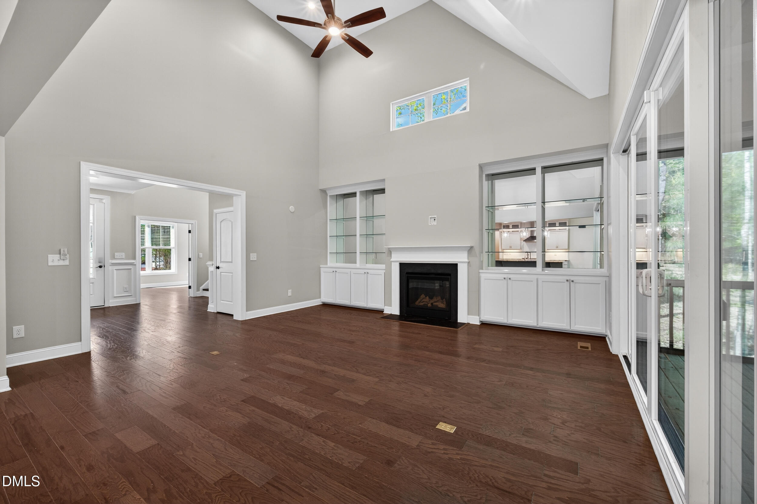231 High Ridge Lane Pittsboro, NC 27312 - Photo 14 of 47 a view of a livingroom with wooden floor a fireplace and windows