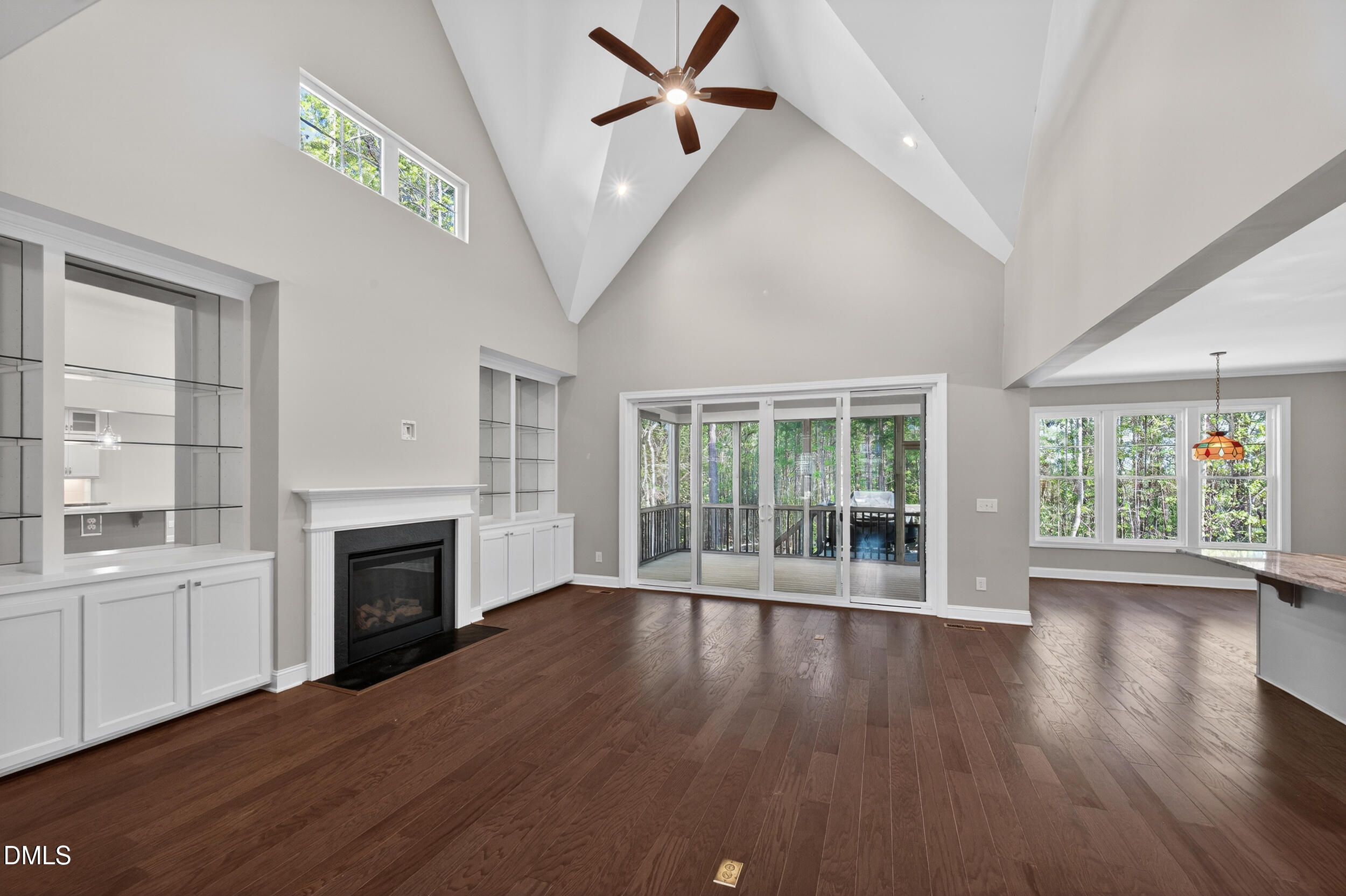 231 High Ridge Lane Pittsboro, NC 27312 - Photo 3 of 47 an empty room with wooden floor fireplace and windows