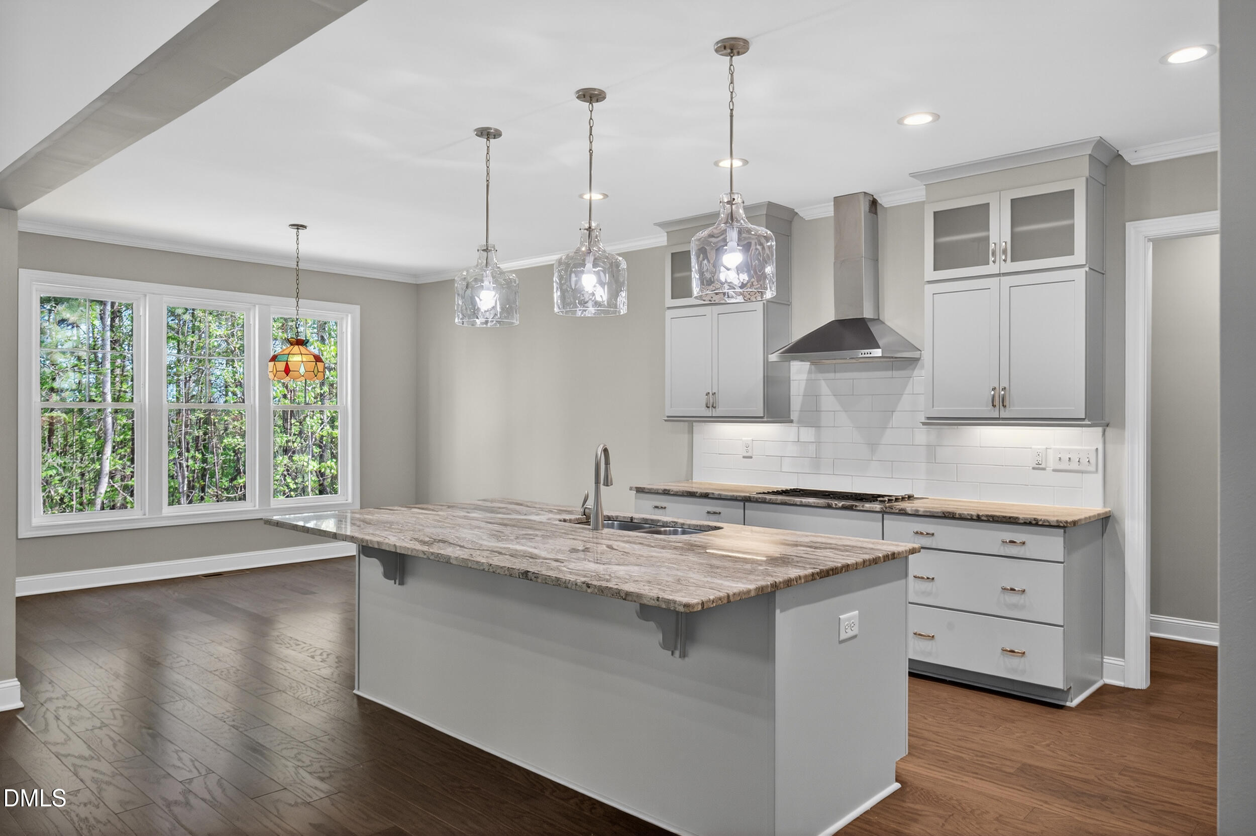 231 High Ridge Lane Pittsboro, NC 27312 - Photo 4 of 47 a kitchen with kitchen island granite countertop a sink a counter space appliances and cabinets