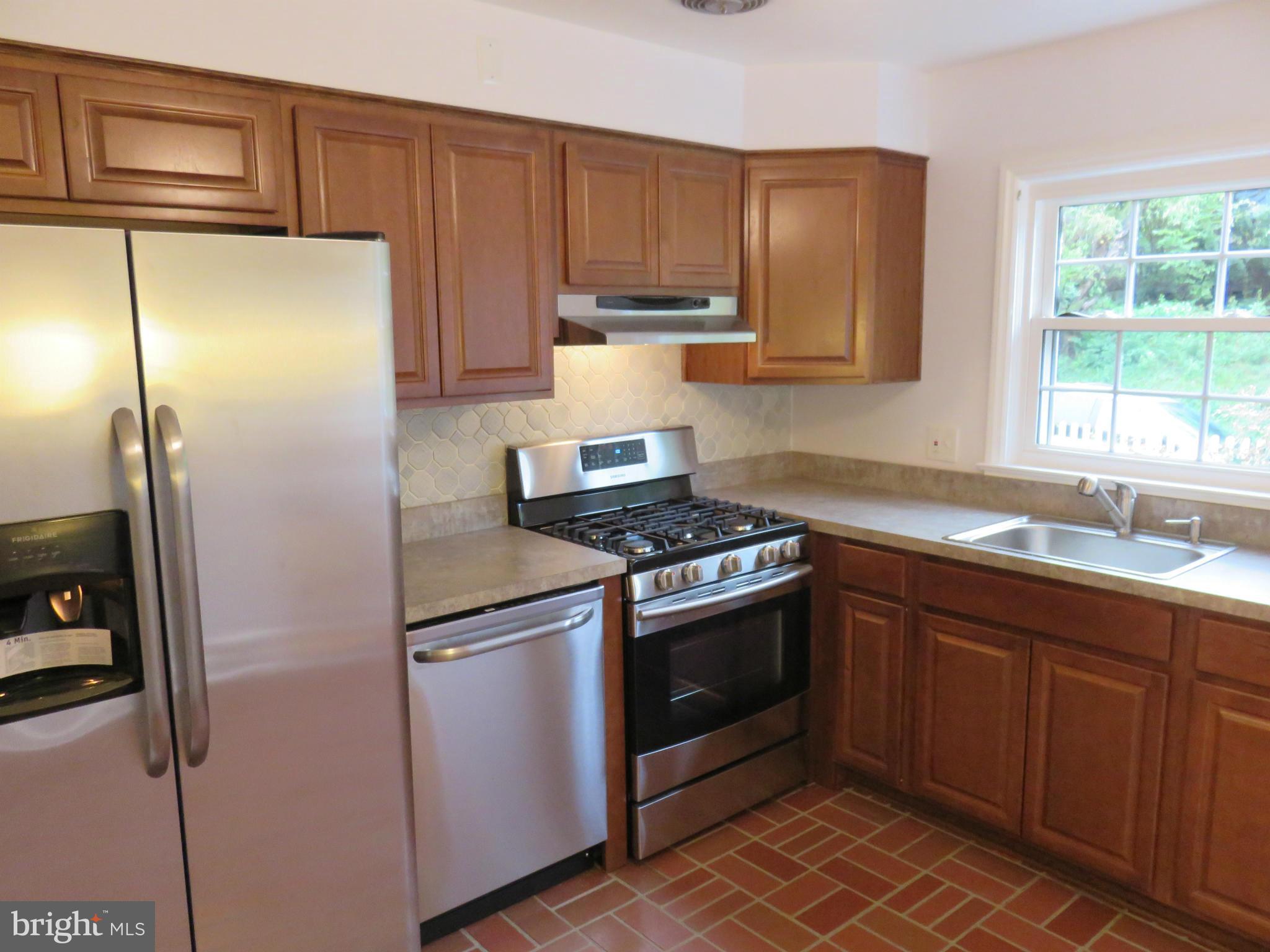 1930 Edgewood Road Baltimore, MD 21286 - Photo 13 of 30 a kitchen with stainless steel appliances granite countertop a refrigerator and a sink