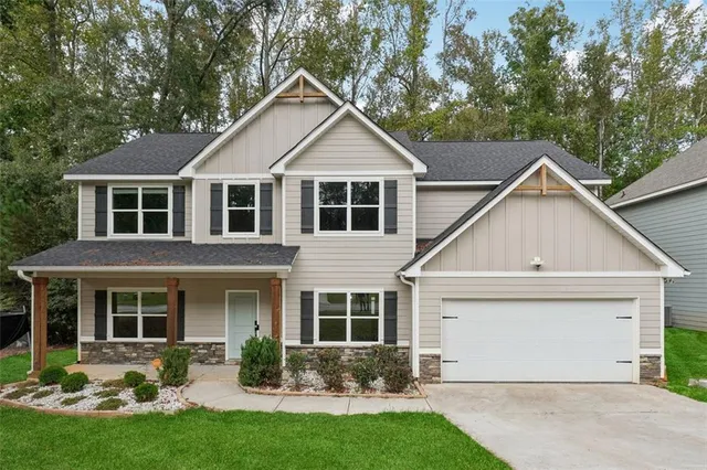 a front view of a house with a yard and porch