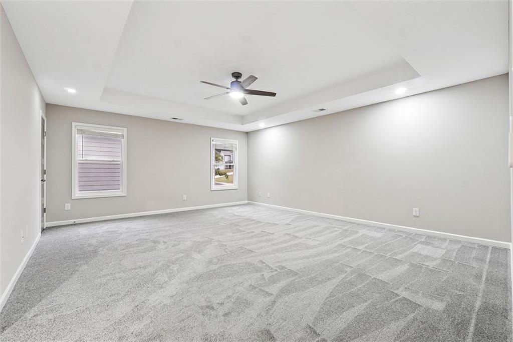 528 Clinton Drive Temple, GA 30179 - Photo 12 of 25 an empty room with windows and ceiling fan