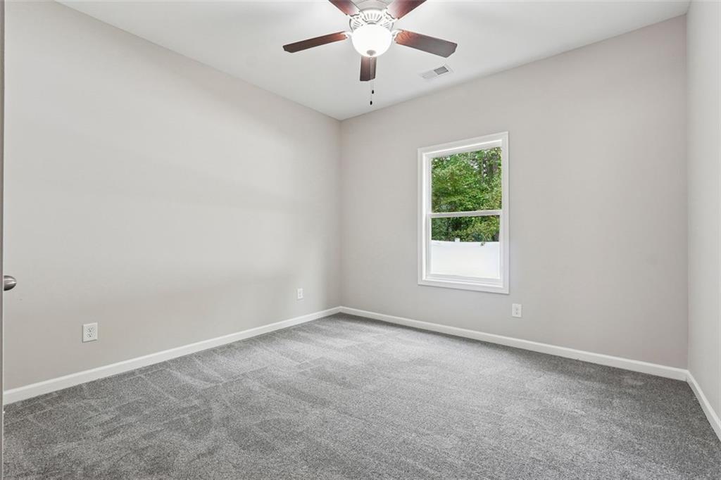 528 Clinton Drive Temple, GA 30179 - Photo 18 of 25 an empty room with a window and a fan