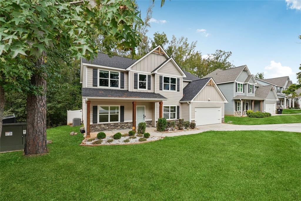 528 Clinton Drive Temple, GA 30179 - Photo 3 of 25 a front view of a house with a garden and trees
