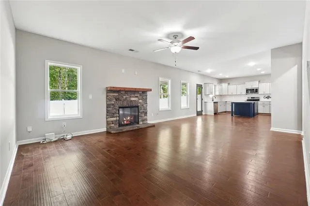a view of a livingroom with furniture wooden floor and a window