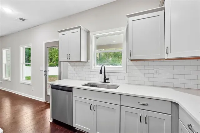 a kitchen with a sink cabinets and window
