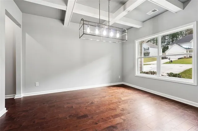 an empty room with a empty space and windows