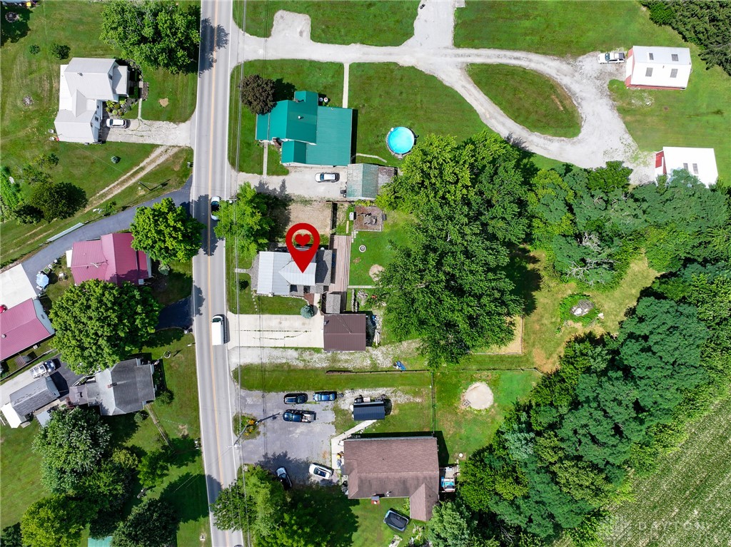 8707 Lytle Ferry Road Waynesville, OH 45068 - Photo 49 of 54 An aerial perspective showcases a residential area with a prominent road, verdant trees, and scattered homes.