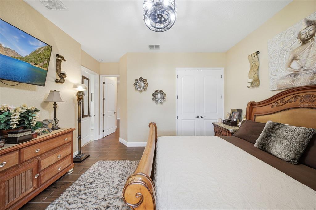13429 Montevista Road Clermont, FL 34711 - Photo 44 of 89 a bedroom with a bed and a dresser in it