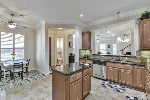 a large kitchen with kitchen island a sink table and chairs