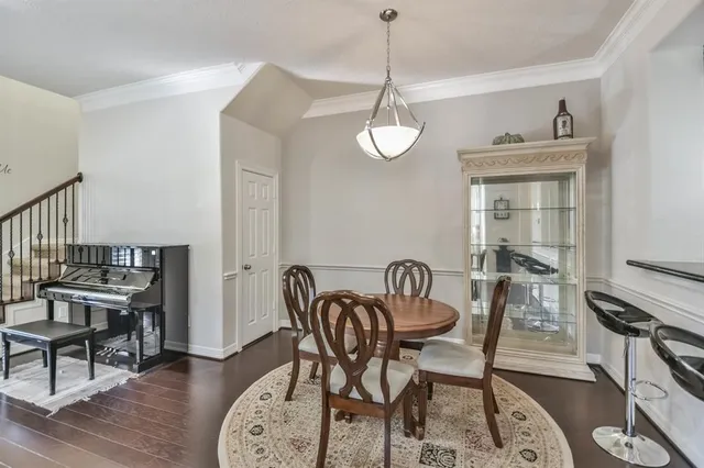 a view of a dining room with furniture wooden floor and a chandelier