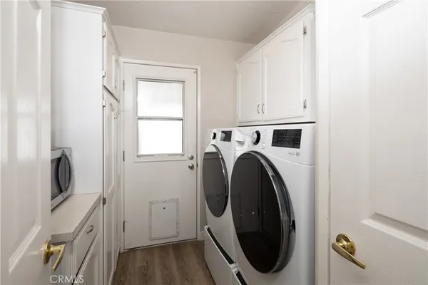a view of a storage and utility room with washer and dryer