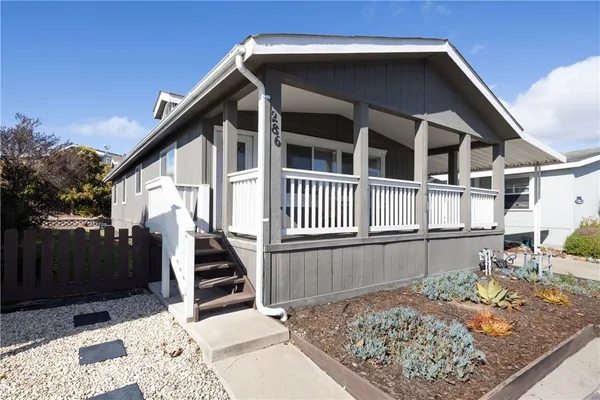 a view of a house with a wooden deck