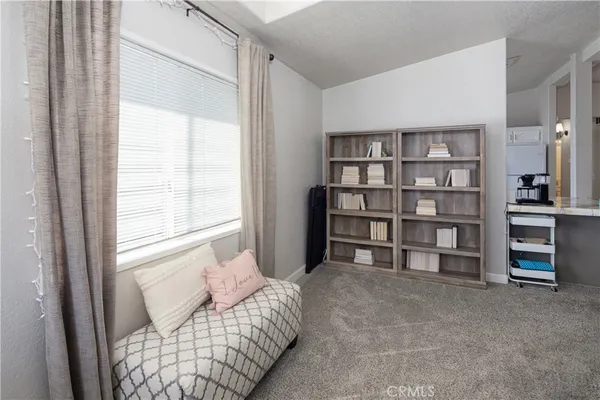 a living room with furniture and a book shelf