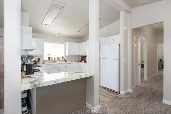a kitchen with kitchen island a sink stainless steel appliances and cabinets