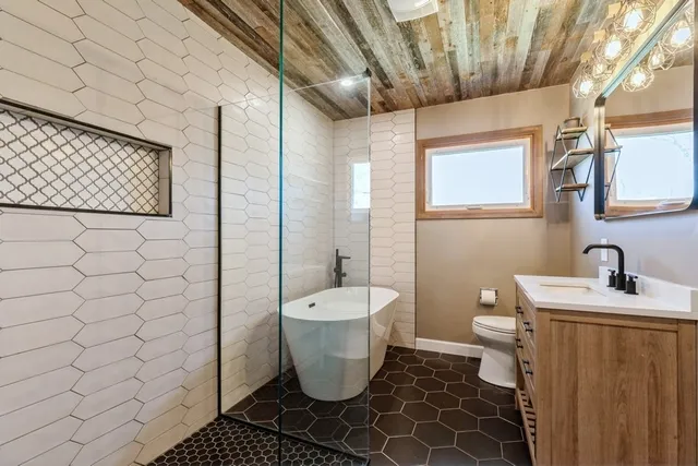 a bathroom with a sink toilet and shower