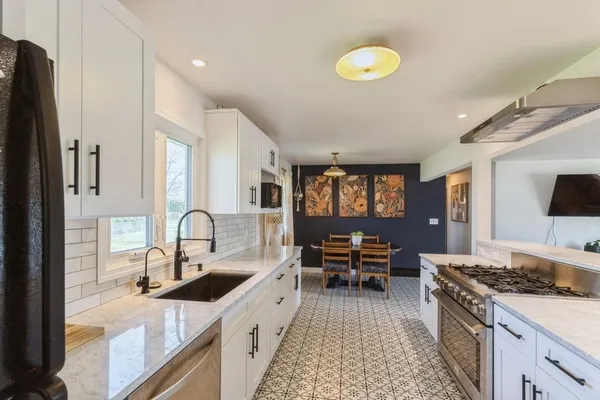 a kitchen with a sink and a stove top oven