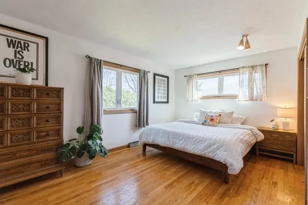 a bedroom with a bed table and a window