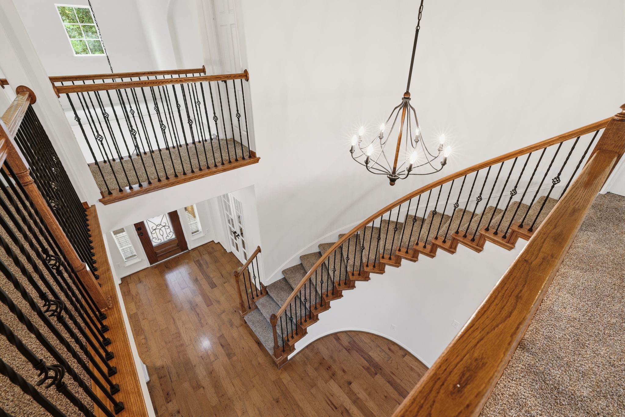 8169 Tranquil Lake Way Conroe, TX 77385 - Photo 12 of 26 a view of stairs and hall with wooden floor