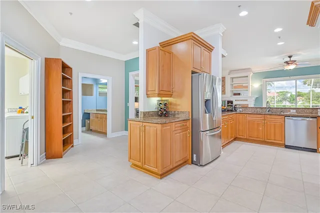 a kitchen with stainless steel appliances granite countertop a refrigerator and a stove top oven