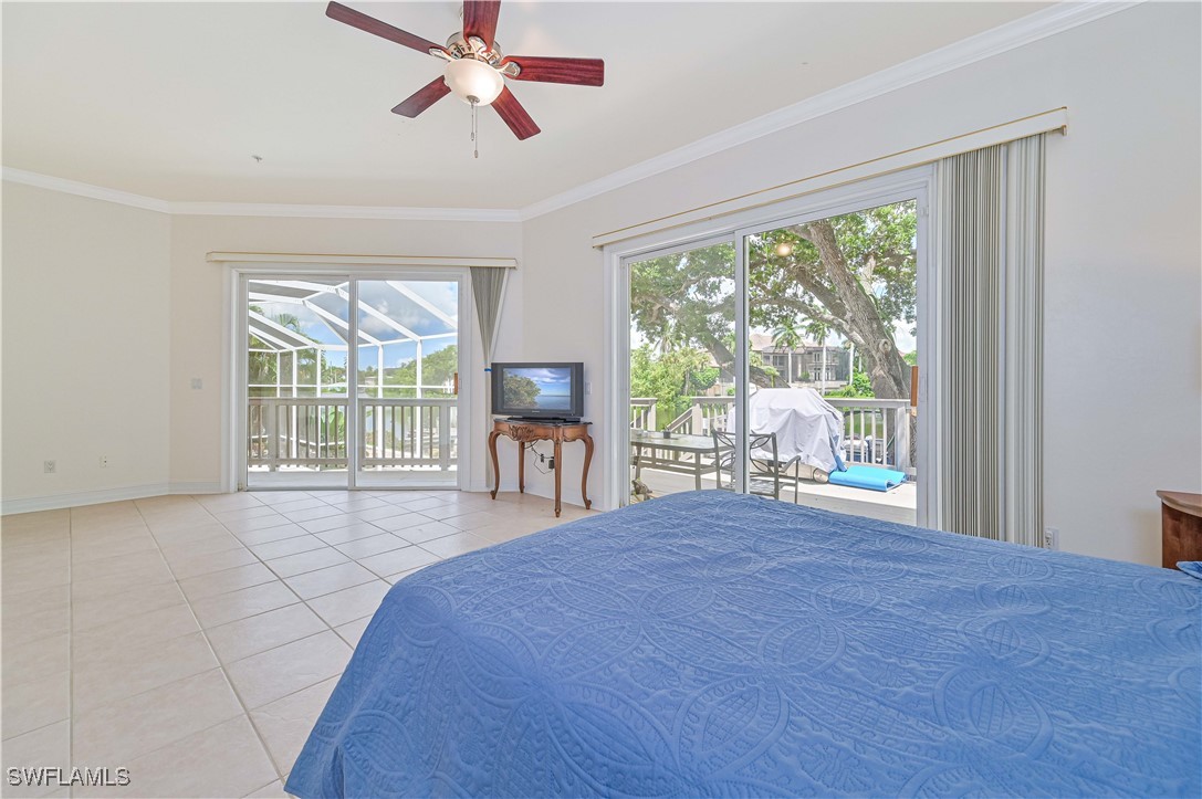 4230 Racoon Bay Drive Bonita Springs, FL 34134 - Photo 32 of 49 a spacious bedroom with a large bed and a large window