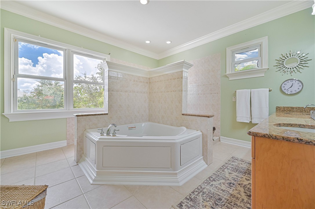4230 Racoon Bay Drive Bonita Springs, FL 34134 - Photo 42 of 49 a bathroom with a sink a toilet and a bathtub