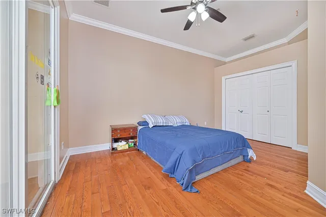 a bedroom with a bed and a ceiling fan