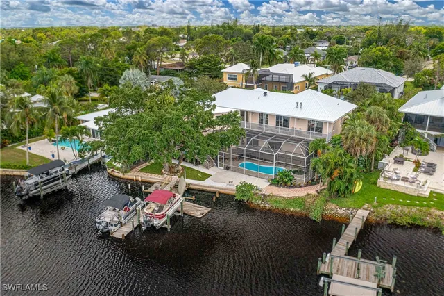 an aerial view of a house with a garden and lake view