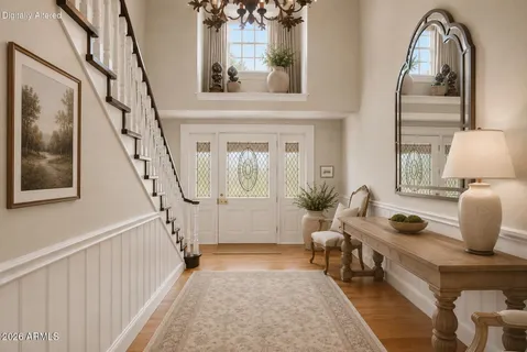 a dining room with furniture a chandelier and wooden floor