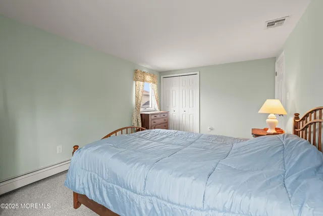 a bathroom with a granite countertop sink a toilet and mirror