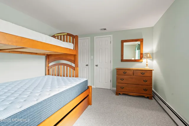 a bathroom with a granite countertop sink toilet and a mirror