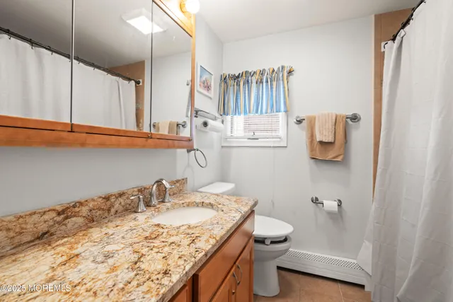 a living room with furniture a flat screen tv and a window