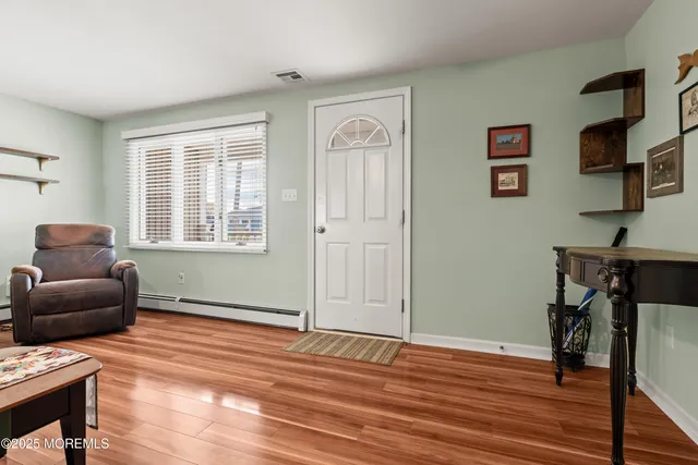 a view of a dining room with furniture window and wooden floor
