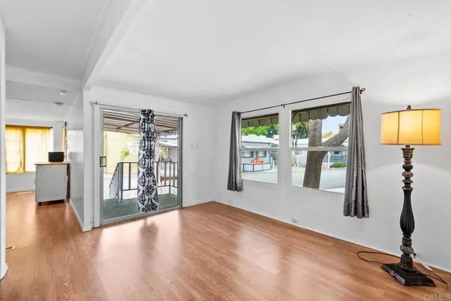 a view of a livingroom with furniture wooden floor and windows