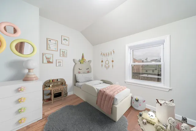 a bedroom with a bed and a window