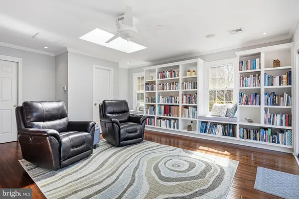 a kitchen with stainless steel appliances granite countertop a stove a sink dishwasher and white cabinets with wooden floor