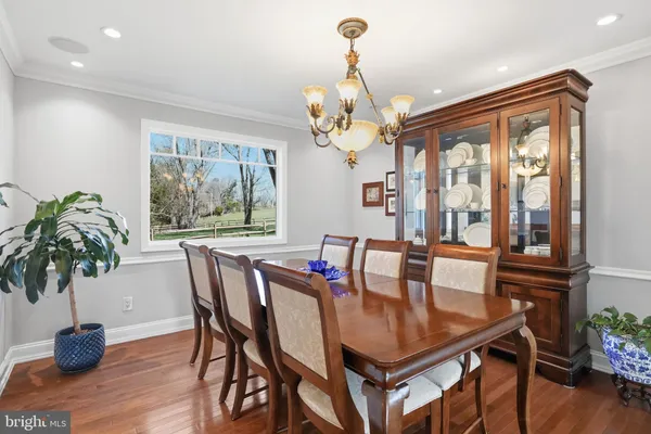a living room with furniture and floor to ceiling windows