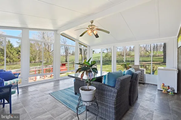 a view of a house with backyard and sitting area