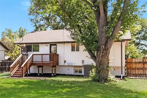 a front view of a house with a yard table and trees