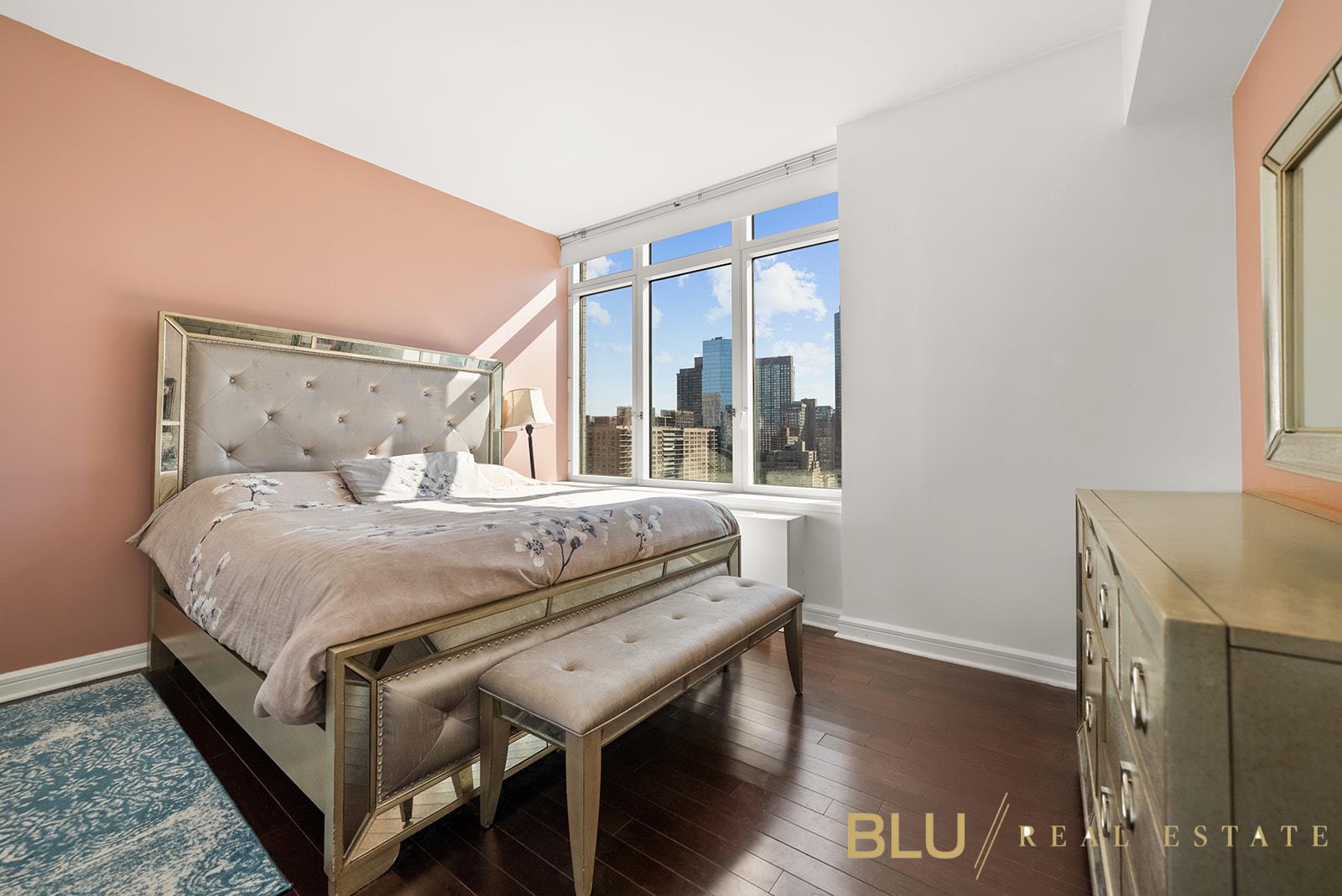 100 Riverside Boulevard, Unit 28E Manhattan, NY 10069 - Photo 3 of 6 a bedroom with a bed and wooden floor