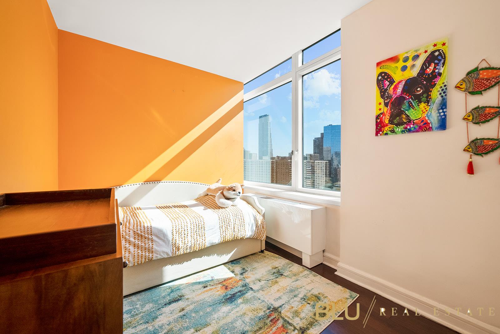 100 Riverside Boulevard, Unit 28E Manhattan, NY 10069 - Photo 5 of 6 a bedroom with a bed and painting on the wall