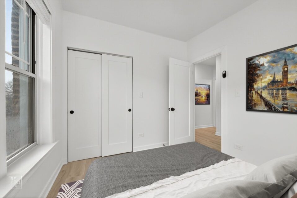 6975 North Bell Avenue, Unit 1 Chicago, IL 60645 - Photo 12 of 16 a bedroom with a bed and painting on the wall