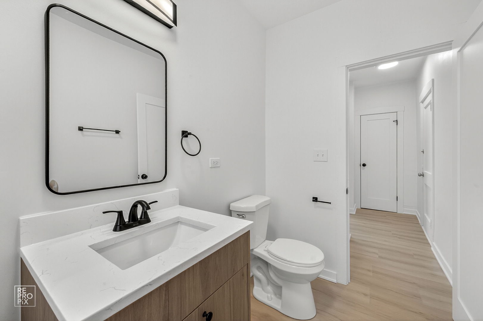 6975 North Bell Avenue, Unit 1 Chicago, IL 60645 - Photo 14 of 16 a bathroom with a sink vanity mirror and toilet