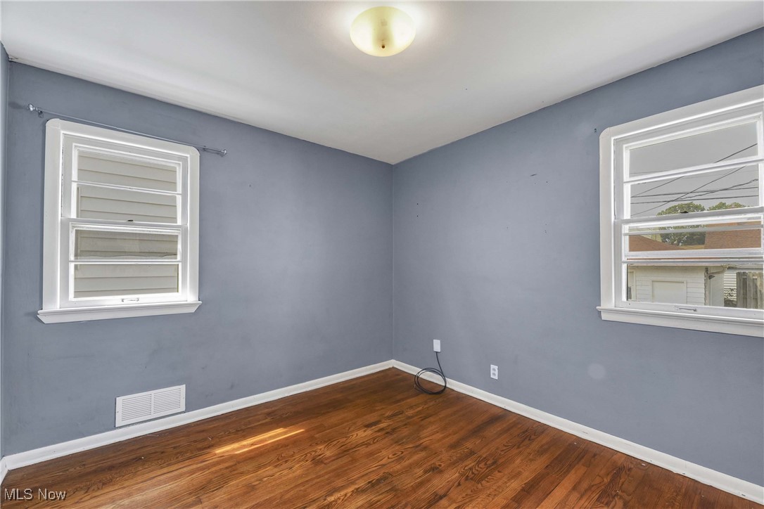 6506 Snow Road Parma, OH 44129 - Photo 17 of 25 Empty room featuring baseboards and dark wood finished floors