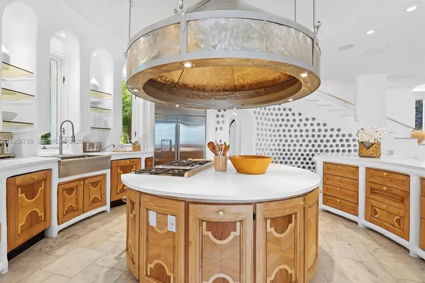a kitchen with stainless steel appliances granite countertop a sink a stove and a wooden floors
