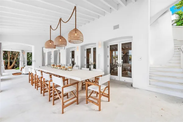 a view of a dining room with furniture and a chandelier