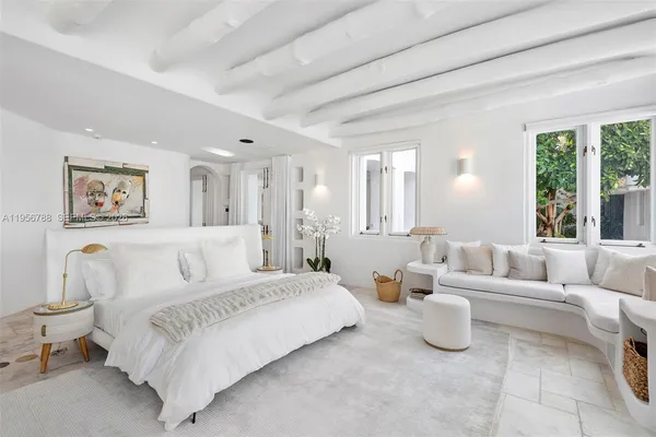 a spacious bedroom with a bed and a couch