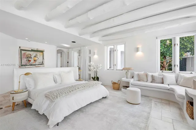 a spacious bedroom with a bed and a couch