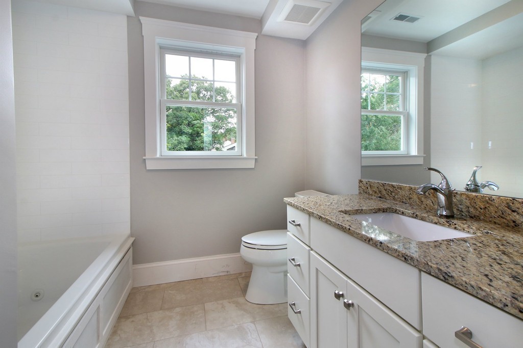 198 Overlook Road Arlington, MA 02474 - Photo 17 of 25 a bathroom with a granite countertop toilet a sink and a window