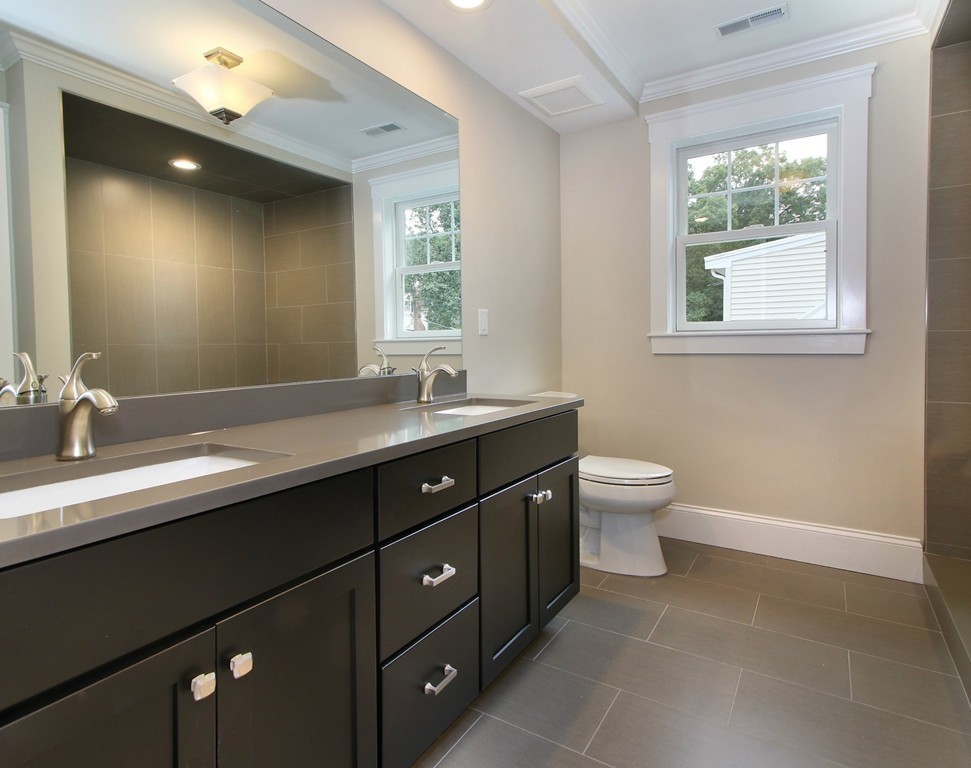 198 Overlook Road Arlington, MA 02474 - Photo 20 of 25 a bathroom with a double vanity sink toilet and a mirror